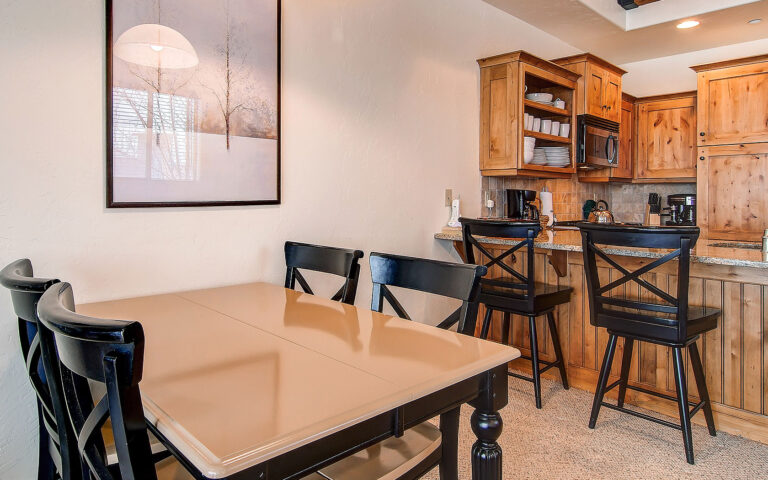 photo of townhome dining table and kitchen with bar stools