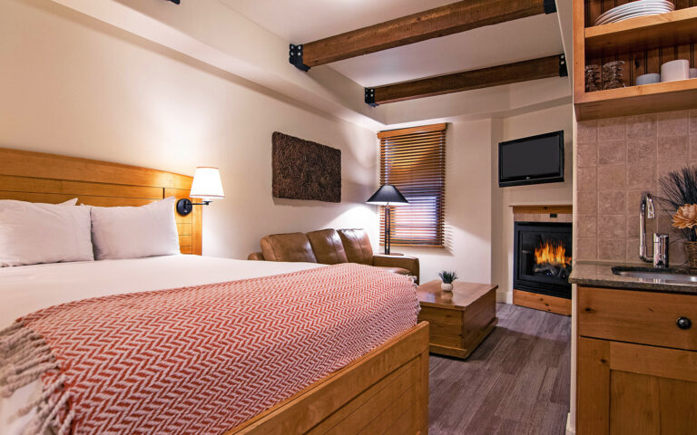 standard room with bed and sofa with wooden accessories