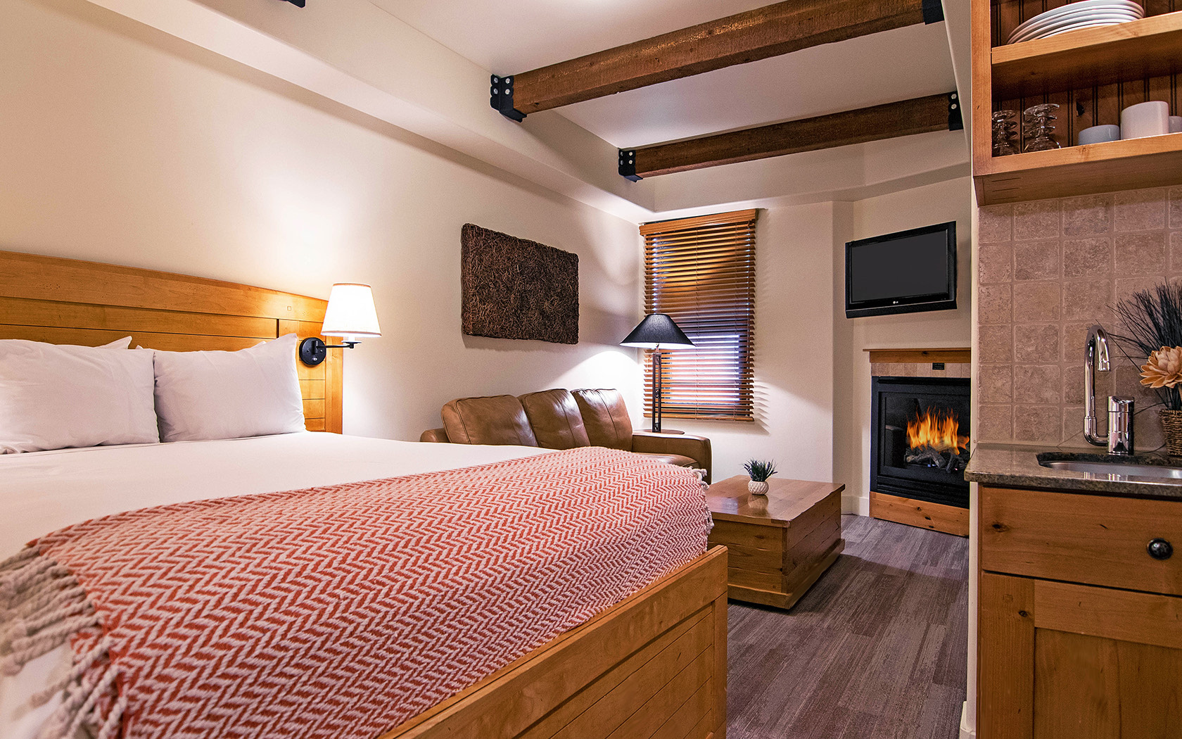 standard room with bed and sofa with wooden accessories