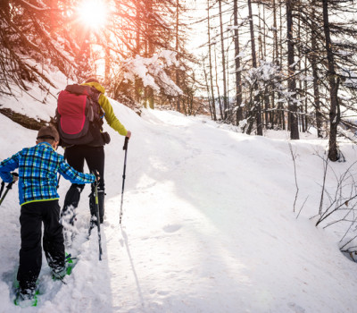 mother and son snowshoeing