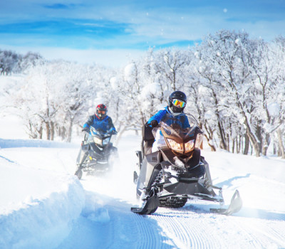 two men on snow mobiles