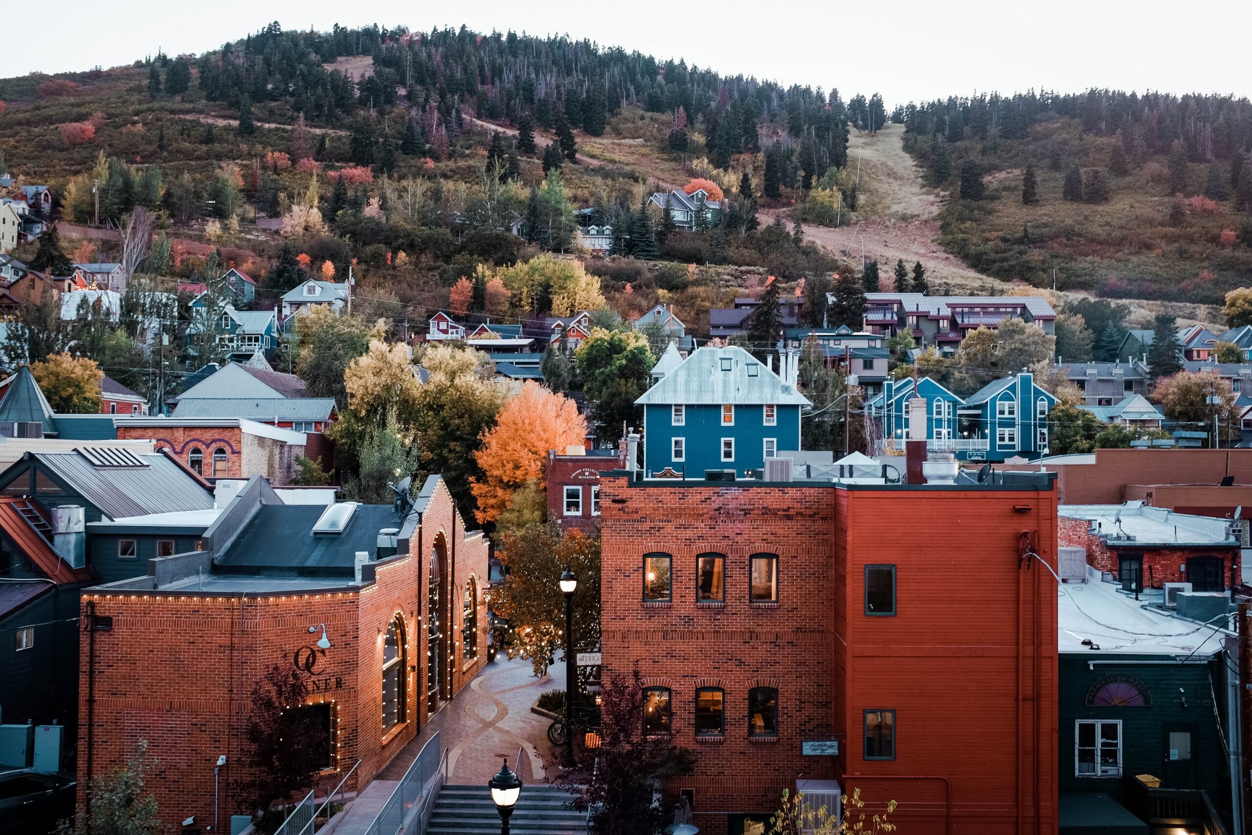 An Autumnal look a section of Park City, UT that rises up a forested hill.