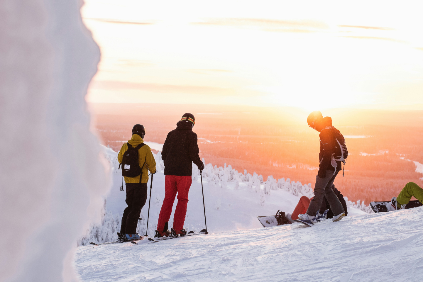 Three skiers on top of a mountain