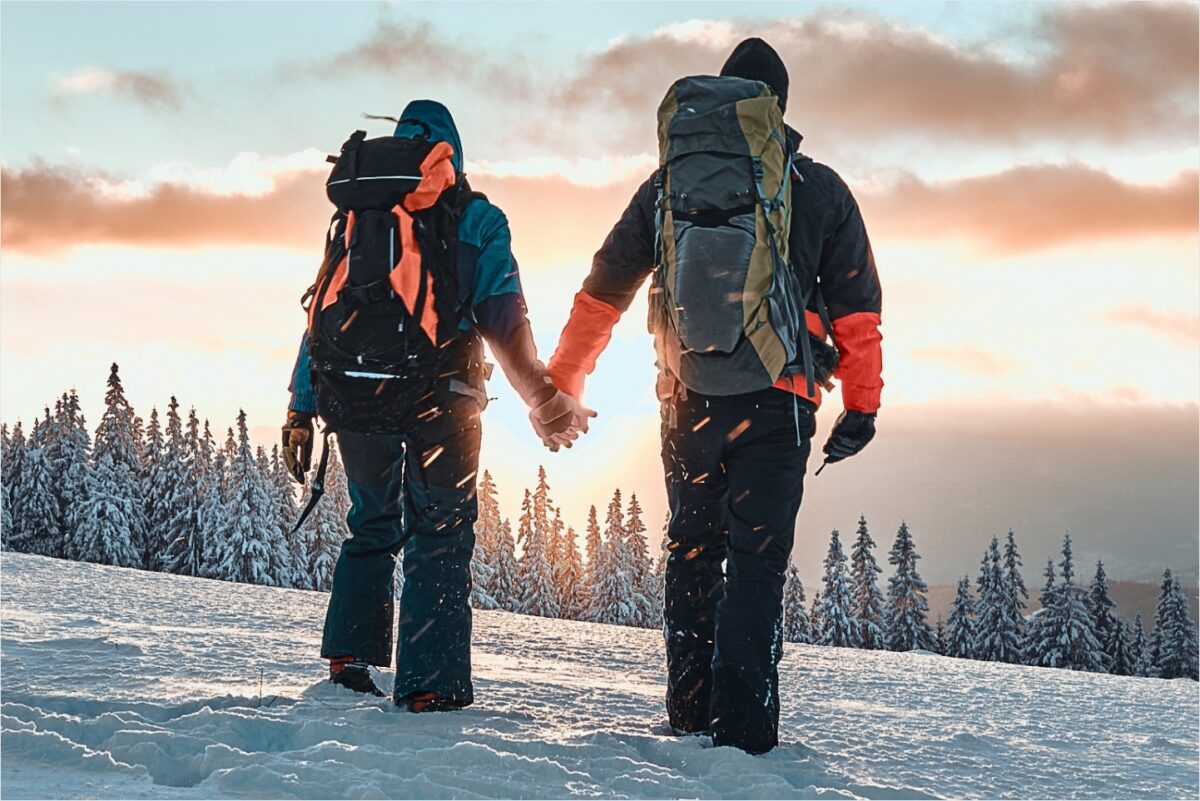 A couple holding hands in the snow.