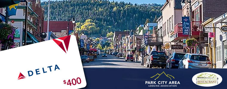 Promotional banner showing a Delta gift card for $400 over a busy town street with shops and parked cars, plus Park City Area Lodging Association and Summit County Restaurant logos in the corner.